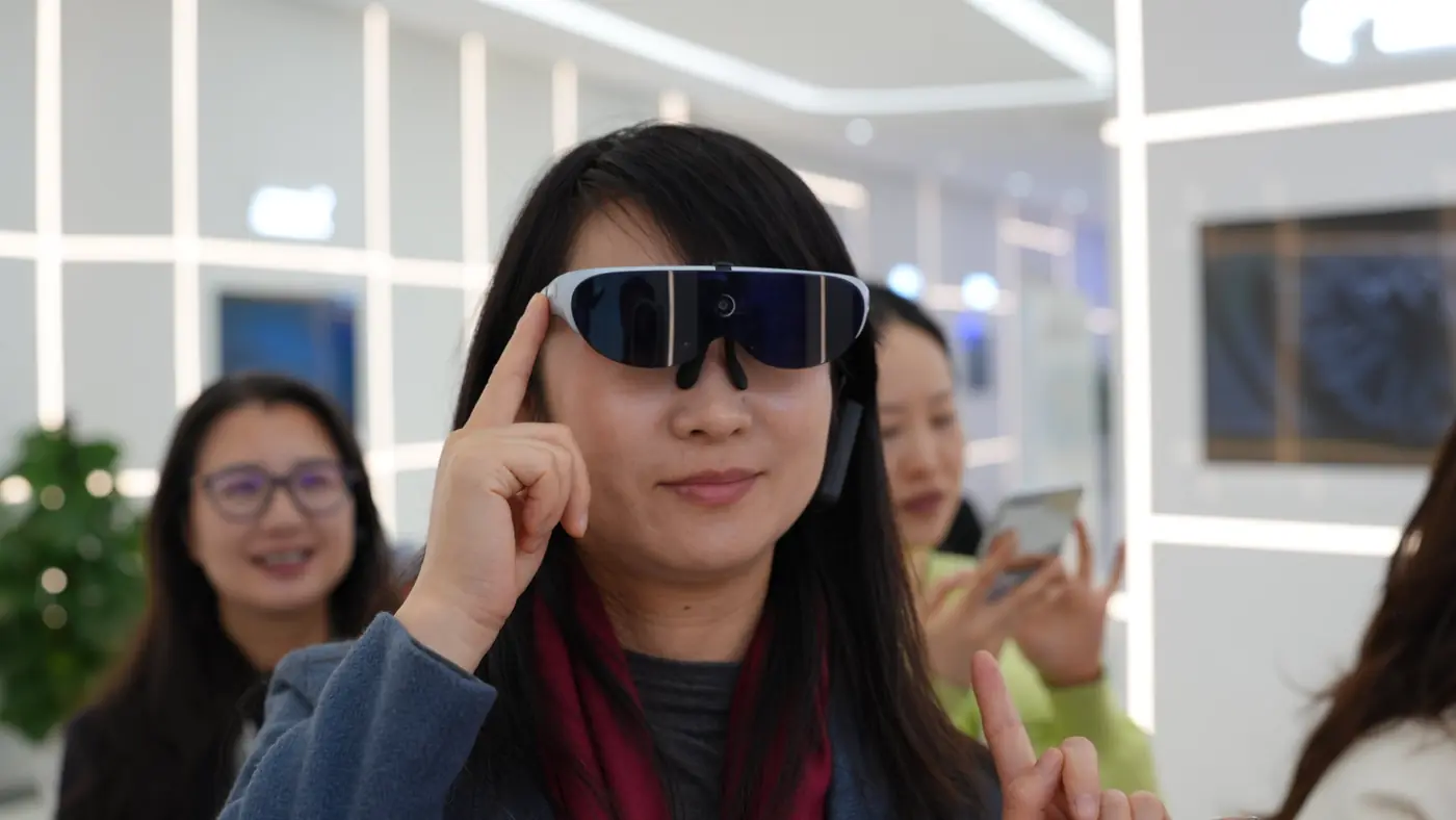A participant tries on AR glasses during a company showroom visit
