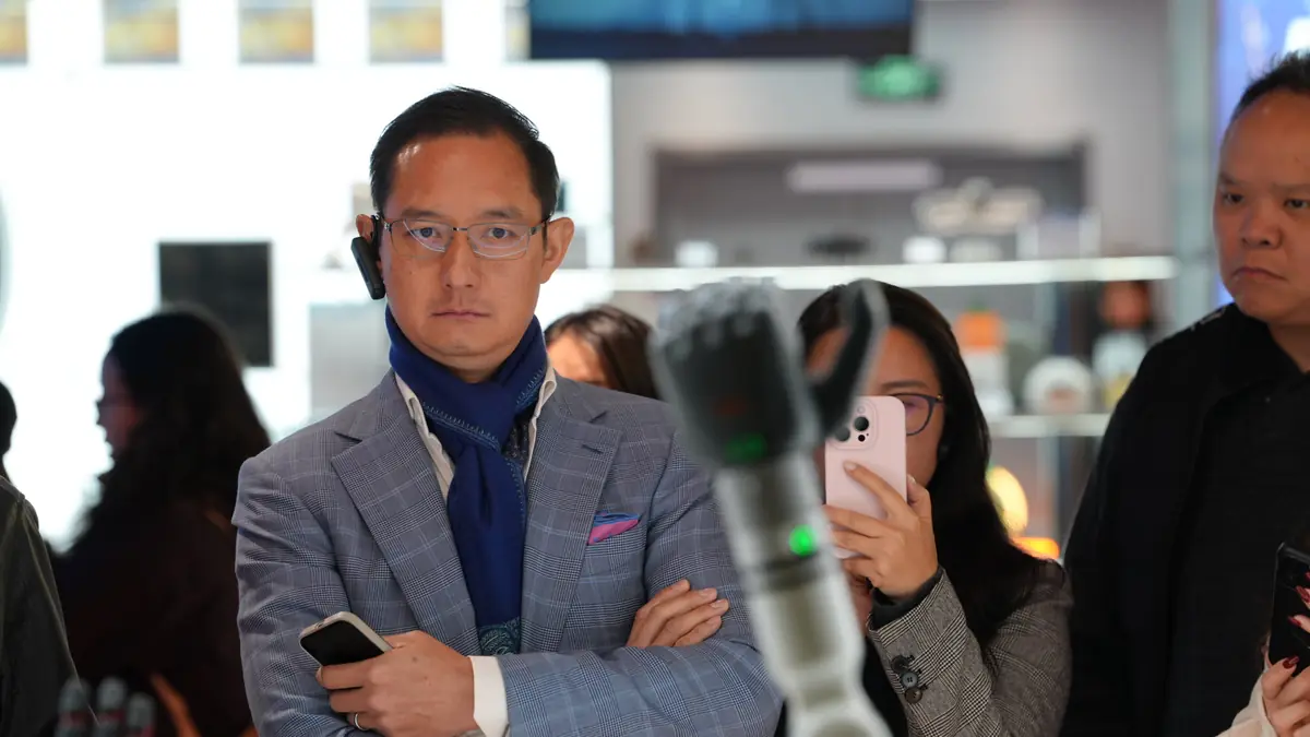 A participant listens during a showroom tour