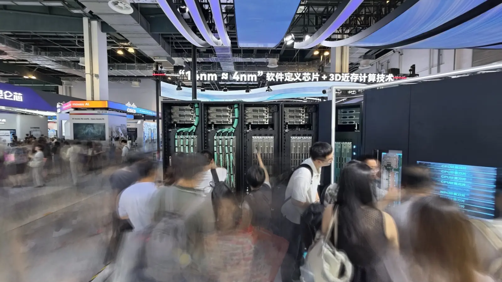 Crowds moving through a technology trade show hall
