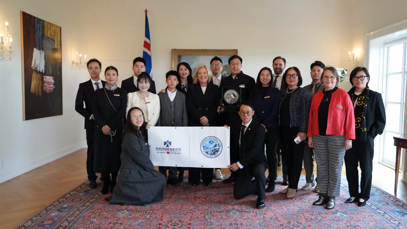 The delegation holding a Thunderbird Alumni Network banner in an Icelandic reception room