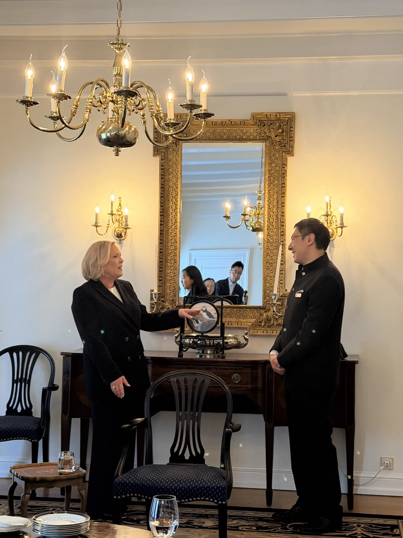 A delegate in conversation with a host during the delegation's official meeting in Iceland
