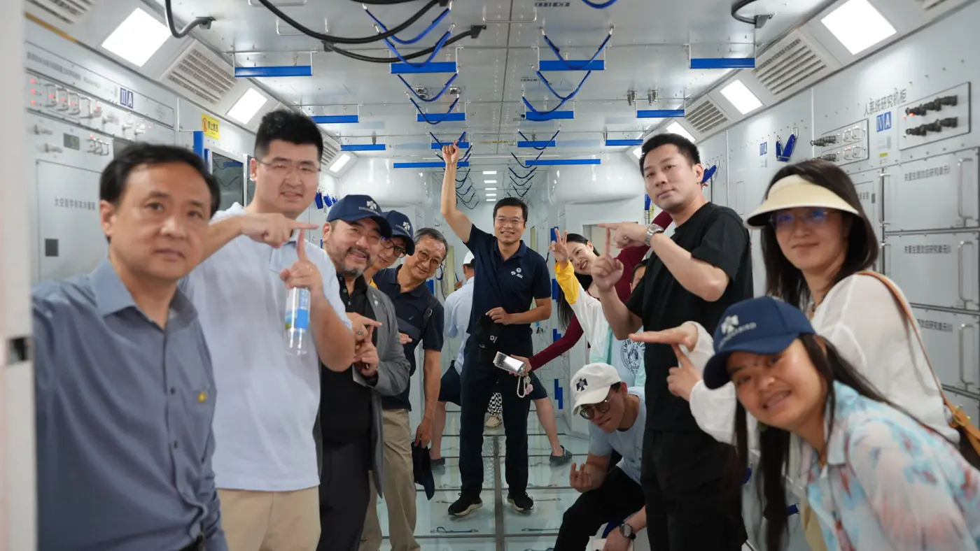 Participants take a group selfie inside a lab