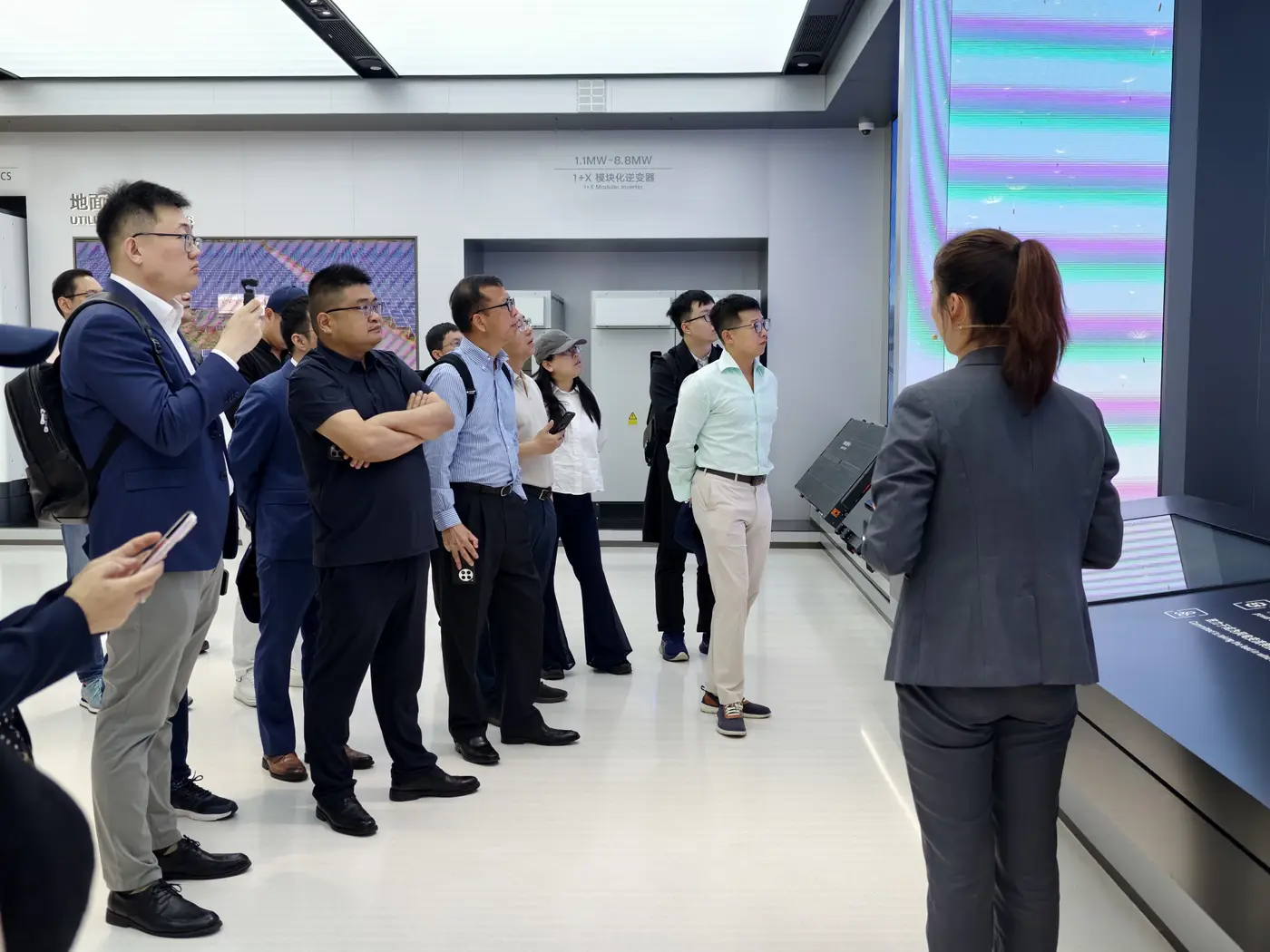 Executives listen to a host during a site visit