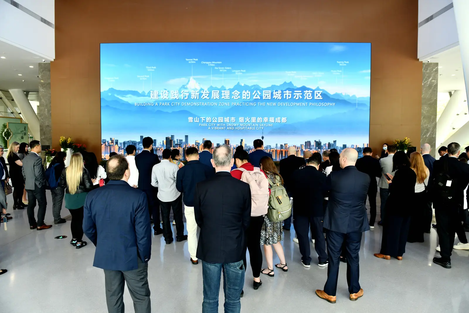 Group attends a welcome briefing in front of a large screen